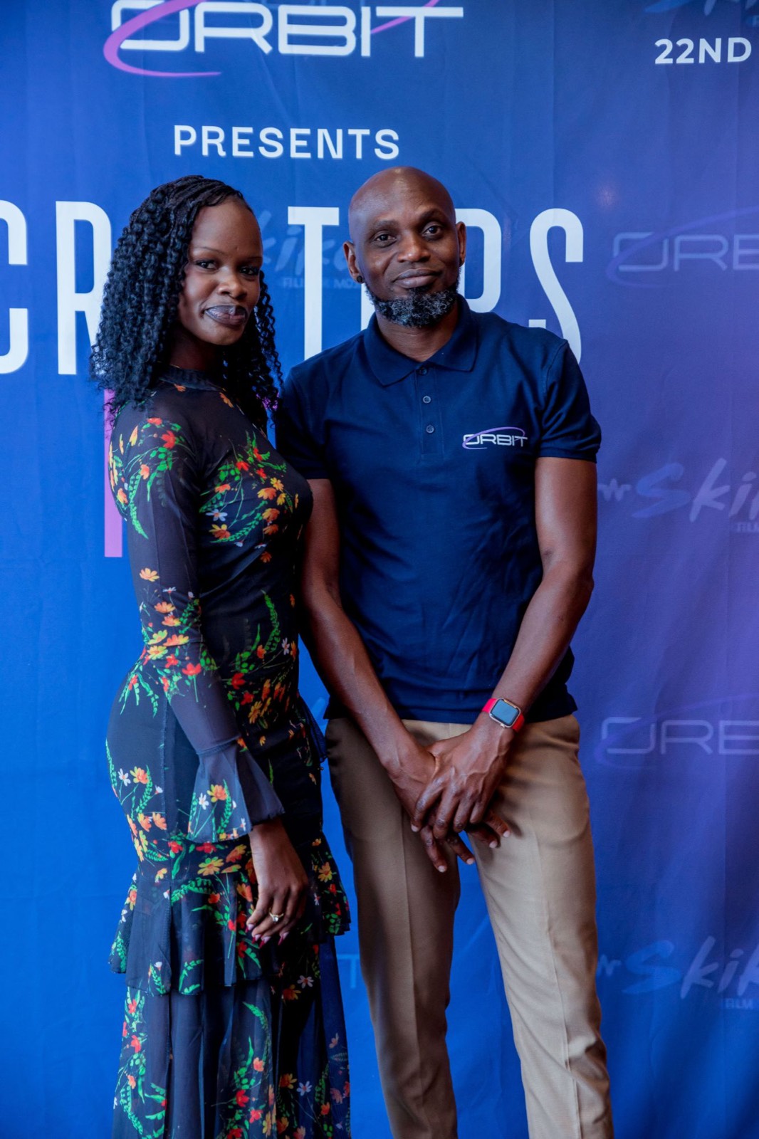 Two guests posing together at the Creators Night backdrop